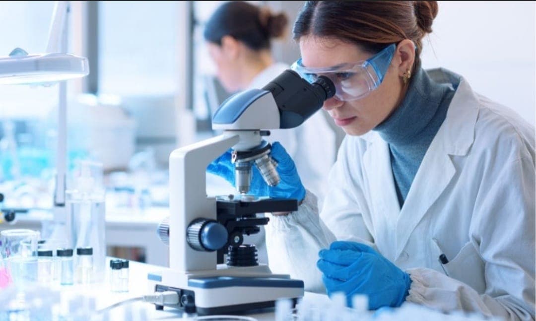 Scientist conducting laboratory research with a microscope