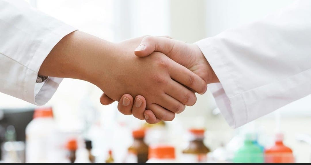 Professional handshake representing partnership with Zunepson Pharma